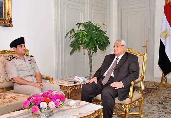 This image released by the office of the Egyptian Presidency shows the Minister of Defense, Lt. Gen. Abdel-Fattah el-Sissi, left, meeting with interim president Adly Mansour , right, at the presidential palace.