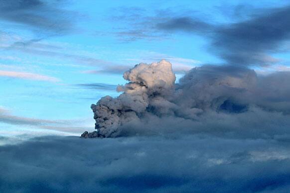 A plume of volcanic ash rises from the Popocatepetl volcano during a brief break from ongoing cloud cover as seen in a flyover near San Mateo Ozolco, Mexico.