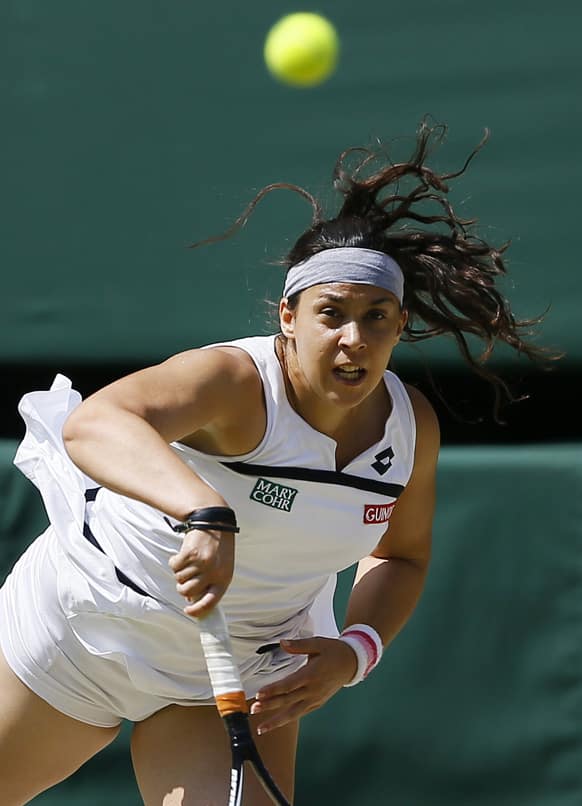 Marion Bartoli of France serves to Sabine Lisicki of Germany during their Women`s singles final match at the All England Lawn Tennis Championships in Wimbledon, London.