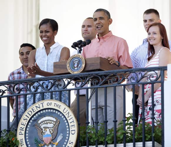 President Barack Obama with first lady Michelle Obama and members of the military, speaks during a Fourth of July celebration on the South Lawn of the White House in Washington.
