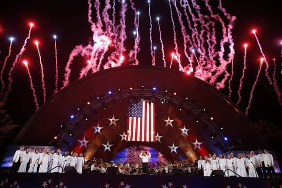 Fireworks burst over the Hatch Shell during the finale of the Boston Pops Fourth of July Concert in Boston.