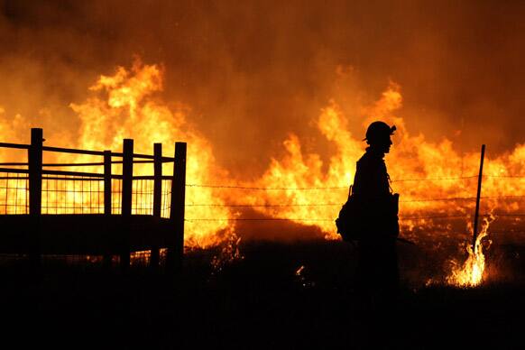 Members of Flame Catchers, a private contractor, work during a back burn on the 2,000-acre Bray Lake Fire, north of Bliss, Idaho.
