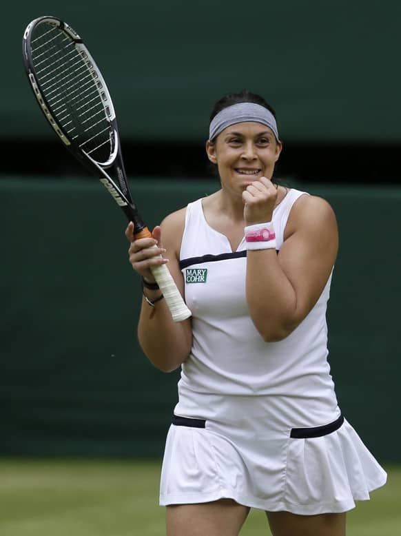 Marion Bartoli of France reacts after defeating Kirsten Flipkens of Belgium during their Women`s singles semifinal match at the All England Lawn Tennis Championships in Wimbledon, London.