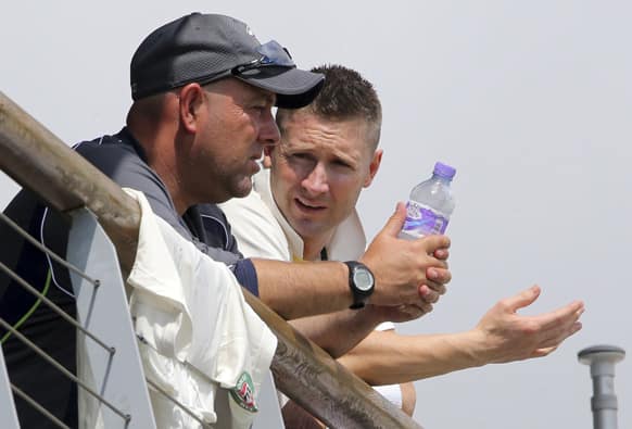 Australia`s cricket captain Michael Clarke speaks with coach Darren Lehmann during day three of their warm up match against Worcestershire at New Road Worcester England.
