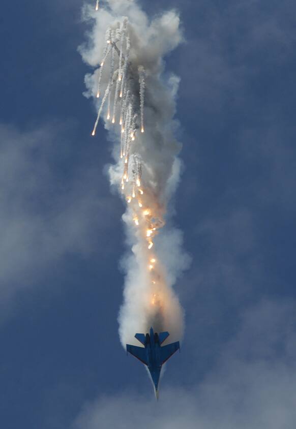 An Su-27 jet of the aerobatics team Russkiye Vityasy (Russian Knights) releases decoys during a performance at the International Maritime Defense show in St.Petersburg, Russia.