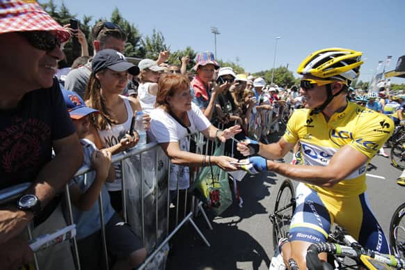 Simon Gerrans of Australia, signs autographs as he waits for the start of the sixth stage of the Tour de France cycling race over 176.5 kilometers (110.3 miles) with start in Aix-en-Provence and finish in Montpellier, southern France.
