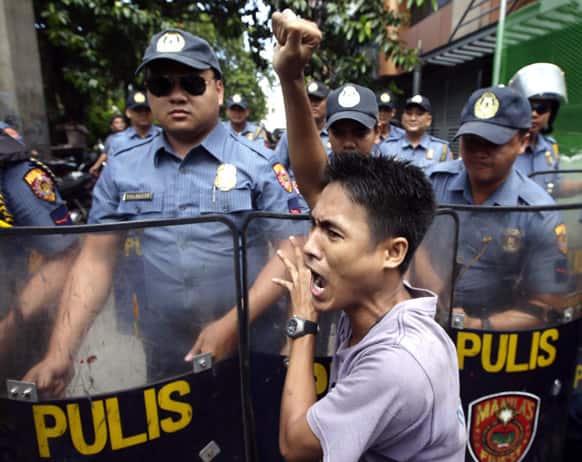 A protester shouts slogans in front of riot police during a rally near US Embassy in Manila, Philippines to coincide with US`s Fourth of July celebrations, which incidentally are observed in the country as Filipino-American Friendship Day.