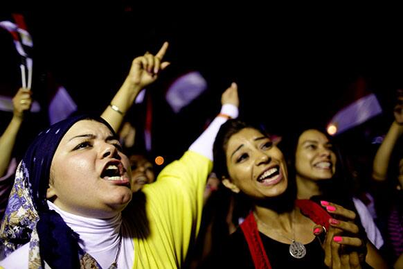 Opponents of Egypt`s Islamist leader Mohammed Morsi celebrate outside the presidential palace in Cairo, Egypt.