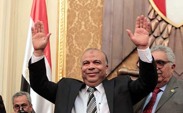 FILE - File photo, Saad el-Katatni, Egypt`s newly-elected parliament speaker gestures during the first session after the revolution that ousted former President Hosni Mubarak, in Cairo, Egypt.