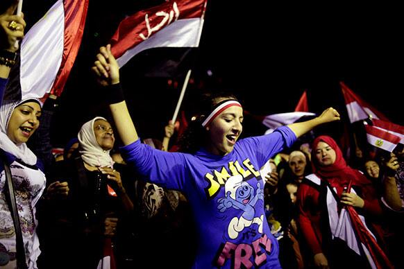 Opponents of Egypt`s Islamist leader Mohammed Morsi celebrate outside the presidential palace in Cairo, Egypt.