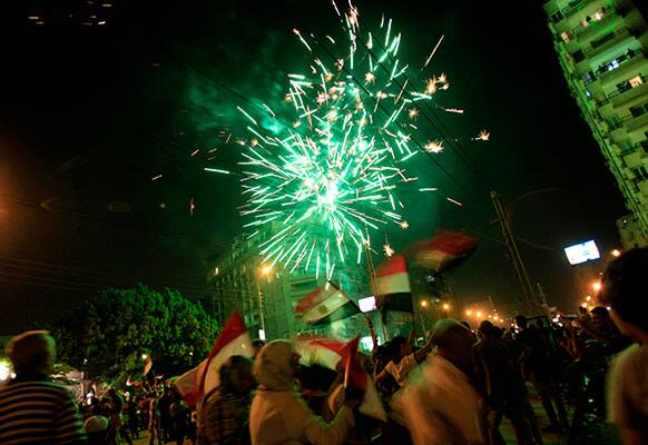 Fireworks light the sky as opponents of Egypt`s Islamist leader Mohammed Morsi celebrate outside the presidential palace in Cairo, Egypt.