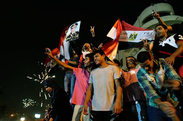 Opponents of Egypt`s Islamist leader Mohammed Morsi celebrate outside the presidential palace in Cairo, Egypt.