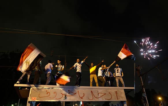 Fireworks light the sky as opponents of Egypt`s Islamist leader Mohammed Morsi celebrate outside the presidential palace in Cairo, Egypt.