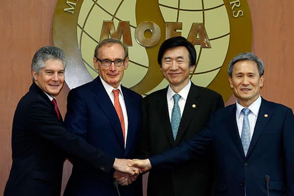 From left to right, Australian Defense Minister Stephen Smith, Australian Foreign Minister Bob Carr, South Korean Foreign Minister Yun Byung-se and South Korean Defense Minister Kim Kwan-jin shake hands before their meeting at the Foreign Ministry in Seoul, South Korea.