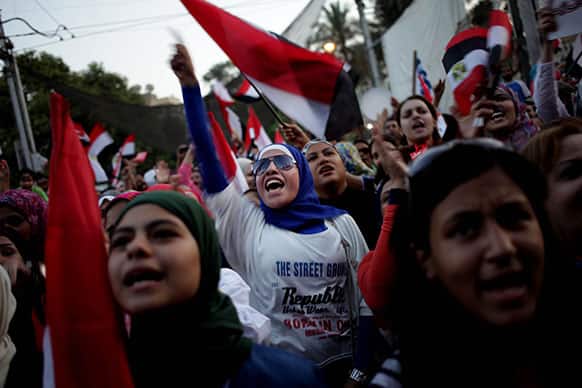 Opponents of Egypt`s Islamist President Mohammed Morsi chant slogans as they celebrate outside the presidential palace in Cairo, Egypt.