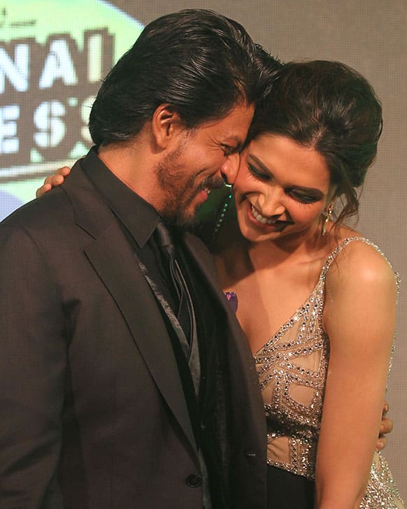 Bollywood star Shah Rukh Khan, left shares light moment with co actor Deepika Padukone during the music release his upcoming movie