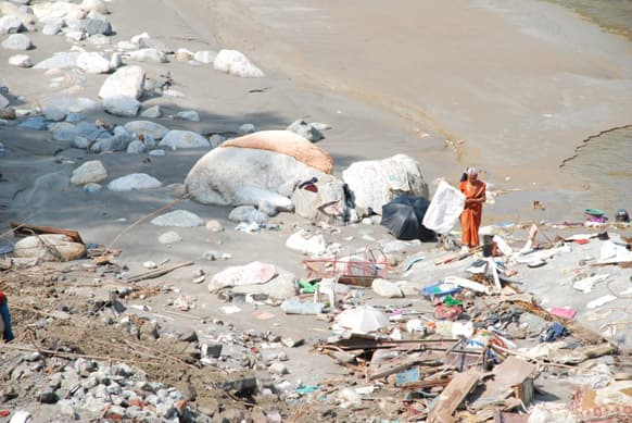A woman tries to salvage, the little that is left of her belongings in Chandrapuri Village/ Town, Rudraprayag District. Her house stood on the river front have been completely washed away by the June 16th Floods. Photo Credit: Siddharth Behl/ SEEDS