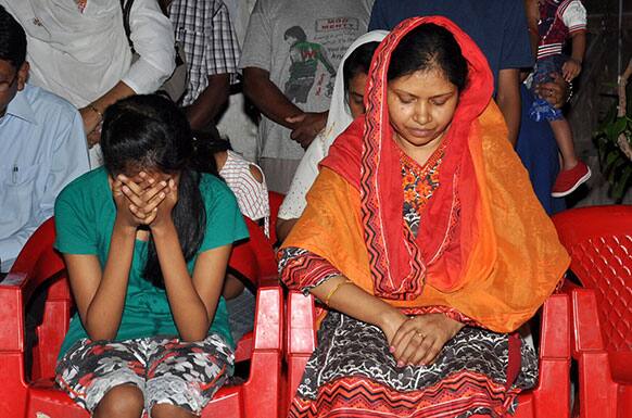 Suman Lata Balihar, wife of Amarjit Balihar who was killed in a Maoist attack, and her daughter mourn at their residence in Ranchi, in the eastern Indian state of Jharkhand.
