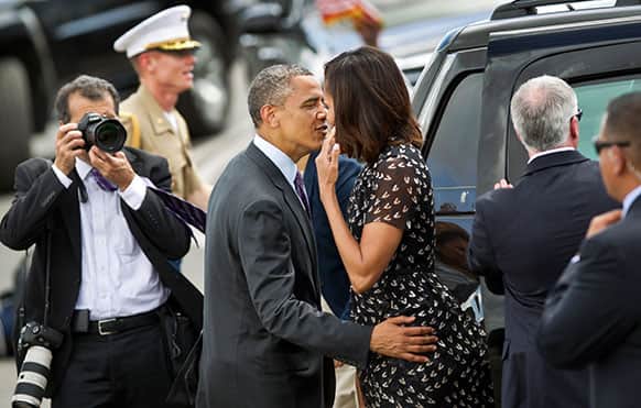 US President Barack Obama kisses First Lady Michelle Obama as they prepare to board Air Force One at the end of the final leg of their weeklong visit to Africa, at the Julius Nyerere airport in Dar es Salaam, Tanzania.