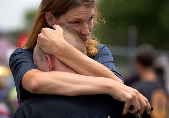 E.A. Vincent, right, holds her son, Dakota Vincent, 13, while visiting the memorial outside the Granite Mountain Interagency Hotshot Crew fire station, in Prescott, Ariz.