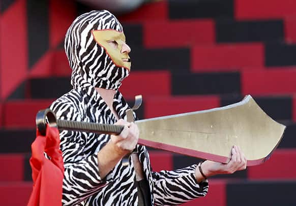 An actor holds a sword during a rehearsal of the opera