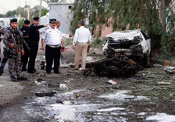 Security forces inspect the scene of a car bomb attack in Basra, 340 miles (550 kilometers) southeast of Baghdad.