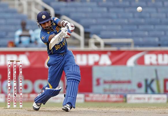 Mahela Jayawardene plays a shot for four runs off Umesh Yadav during their Tri-Nation Series cricket match in Kingston, Jamaica.