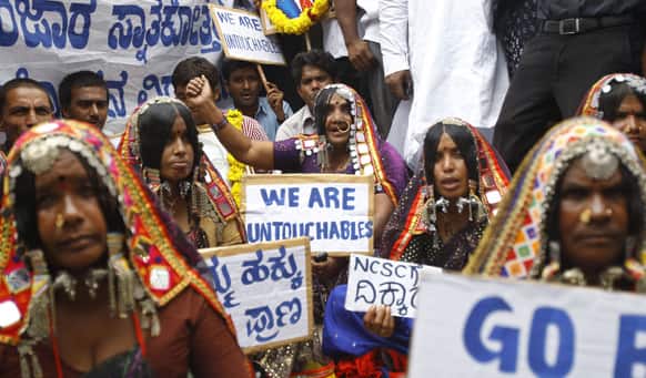 Tribal women of the Banjara community shout slogans demanding their rights during a protest outside the venue of a public hearing held by the National Commission of Scheduled Castes in Bangalore.
