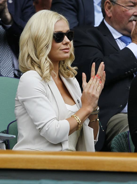 Singer Katherine Jenkins applauds as Agnieszka Radwanska of Poland faces Li Na of China in a Women`s singles quarterfinal match at the All England Lawn Tennis Championships in Wimbledon, London.