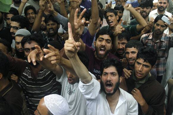 Kashmiri villagers shout slogans near the body of Shahnawaz Mir, a suspected militant commander of Hizb-ul Mujahedeen, Kashmir`s biggest rebel group, during his funeral at Tral, some 40 kilometers (25 miles) south of Srinagar.