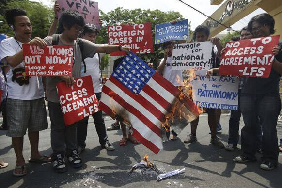Filipino students burn a mock US flag during a rally in Manila, Philippines. The group reiterates their call for US troops to stay away from the country.