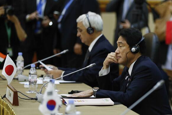 Japan`s Foreign Minister Fumio Kishida, right, and India`s Foreign Minister Salman Khurshid wait for the start of the 3rd East Asia Summit (EAS) Foreign Ministers` Meeting in Bandar Seri Begawan, Brunei.