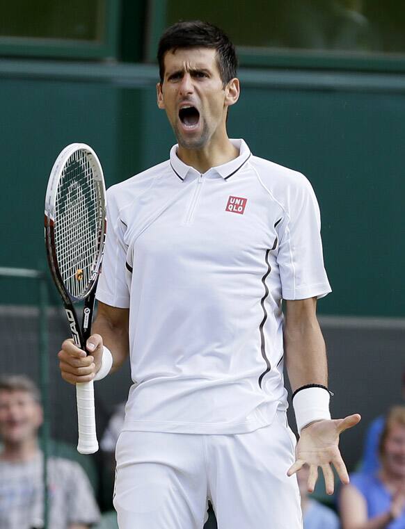 Novak Djokovic of Serbia reacts after winning a point against Tommy Haas of Germany during a Men`s singles match at the All England Lawn Tennis Championships in Wimbledon.