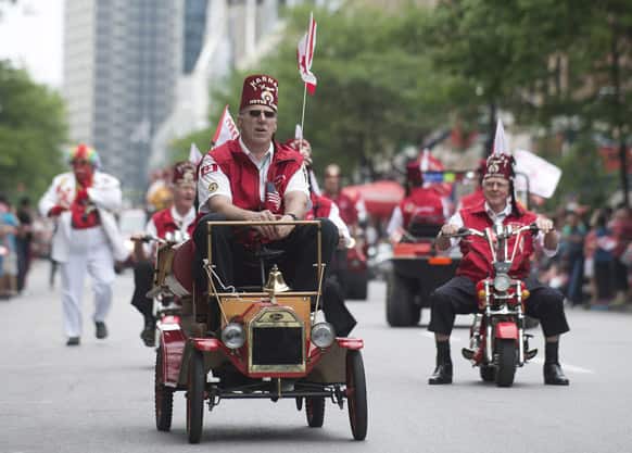 Members of the Shriners drive miniature vehicles as they participate in the annual Canada Day parade in Montreal.