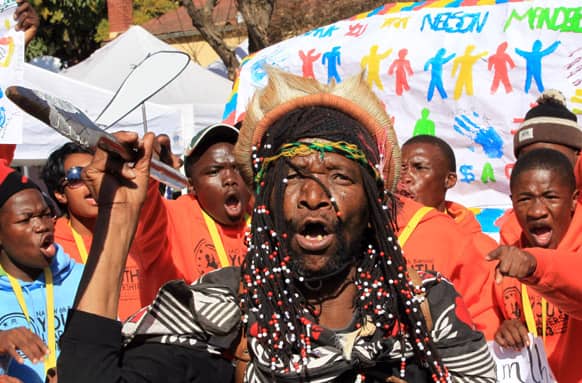 Mamogodi Sello, center, with a youth group sing outside the Mediclinic Heart Hospital where former South African President Nelson Mandela is being treated in Pretoria, South Africa.