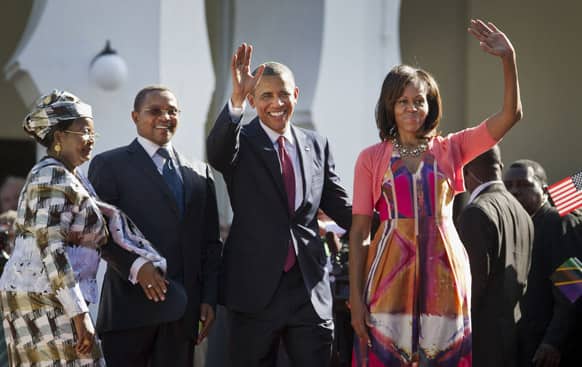 US President Barack Obama, and first lady Michelle Obama, wave as they enter State House accompanied by Tanzanian President Jakaya Kikwete, center-left, and Tanzanian First Lady Salma Kikwete, in Dar es Salaam, Tanzania.
