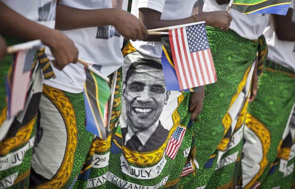 Women wearing skirts with the face of US President Barack Obama rehearse their singing ahead of welcoming him for his planned meeting with Tanzanian President Jakaya Kikwete, outside State House in Dar es Salaam, Tanzania.