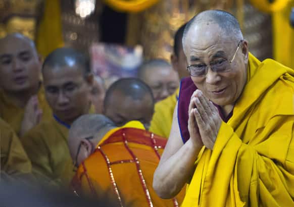 Tibetan spiritual leader the Dalai Lama greets devotees as he arrives to give a religious talk at the Tsuglakhang temple in Dharmsala. The two-day talk was organized on request from a Buddhist group in Vietnam.