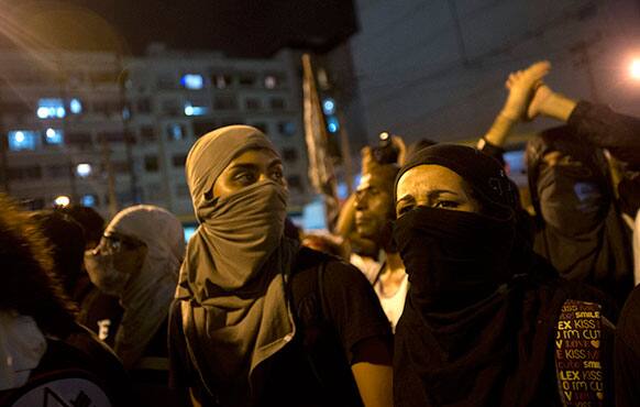 Demonstrators protest near the Maracana stadium during the Confederations Cup final soccer match between Brazil and Spain, in Rio de Janeiro, Brazil.