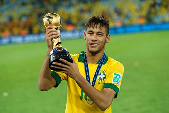 Brazil`s Neymar holds the trophy after winning the soccer Confederations Cup final between Brazil and Spain at the Maracana stadium in Rio de Janeiro, Brazil.
