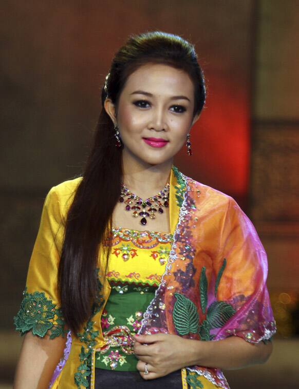 A Myanmar model presents a creation by local designers during a fashion show at the National Theater in Yangon, Myanmar.