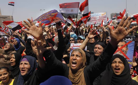 Egyptian protesters chant slogans and hold anti-Egypt`s Islamist President Mohammed Morsi posters during a rally in Tahrir Square, the focal point of Egyptian uprising, in Cairo.