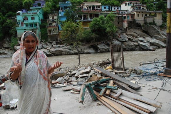 Leela Devi, 56 is standing next to her house washed away by the surging river, Silli Village, Augustyamani. Her only source of income were rental income from the house. Photo Courtesy: Siddharth Behl/SEEDS