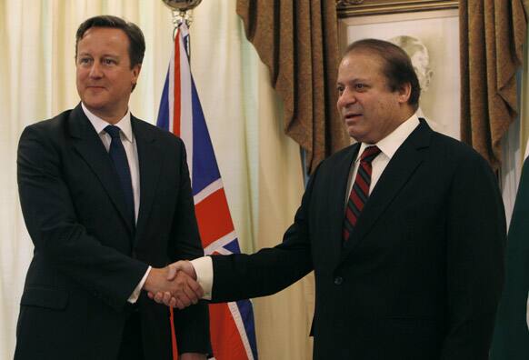 British Prime Minister David Cameron, left, shakes hand with his Pakistani counterpart Nawaz Sharif prior to their meeting in Islamabad, Pakistan.
