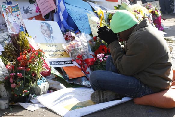 A well-wisher prays in support of former South African President Nelson Mandela at the entrance to the Mediclinic Heart Hospital where Mandela is being treated in Pretoria, South Africa.