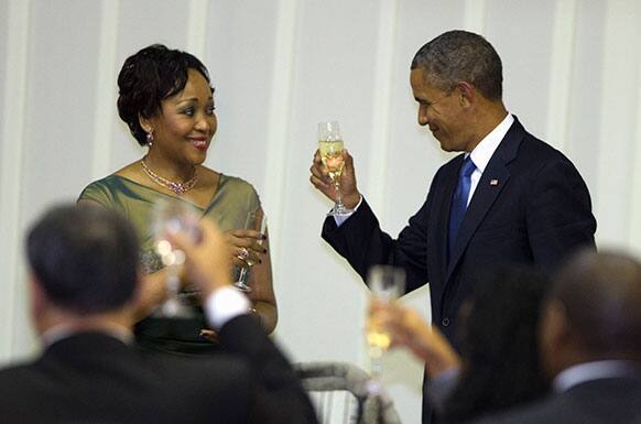 US President Barack Obama, toasts with Thobeka Madiba-Zuma during an official dinner hosted by South African President Jacob Zuma at the Presidential Guest House in Pretoria, South Africa.
