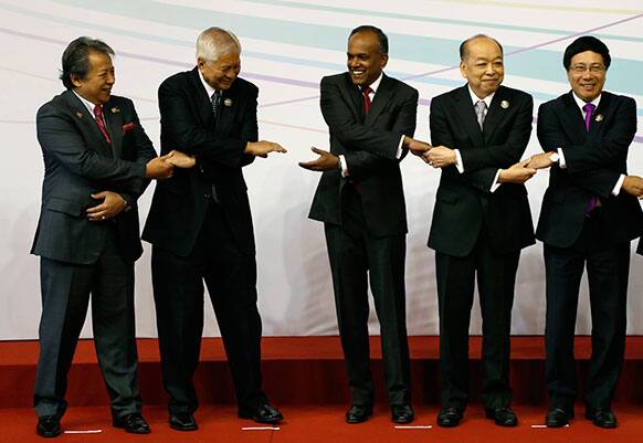 FM of southeast Asian countries from left to right, Malaysia`s Anifah Aman, Philippines` Albert del Rosario, Singapore`s K. Shanmugam and Vietnam`s Pham Binh Minh hold hands as they prepare for a group photo during the opening ceremony of the 46th ASEAN Foreign Ministers` Meeting.