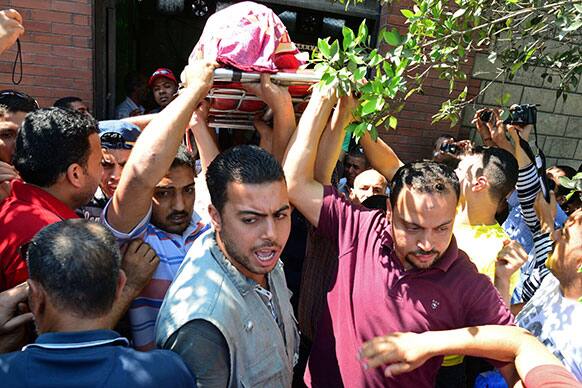 Mourners carry the body of 14 year-old Ahmed Metwally, killed Friday in clashes between opponents and supporters of Egypt`s Islamist President, Mohammed Morsi, in Alexandria.