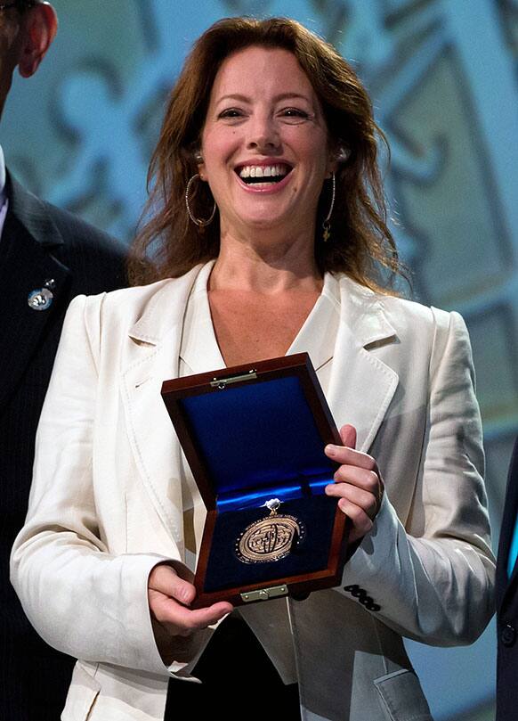 Canadian recording artist Sarah McLachlan holds the Kiwanis International World Service Medal during the organization`s 98th annual convention in Vancouver, B.C.