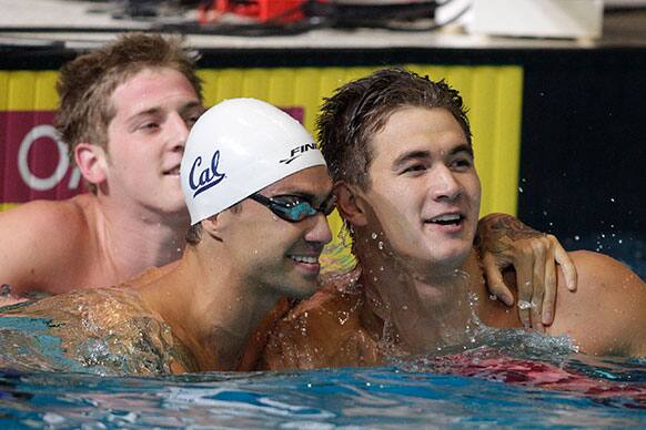 Nathan Adrian, right, is congratulated by Anthony Ervin, center, after winning the men`s 50-meter during the U.S. National Championships swimming meet in Indianapolis.
